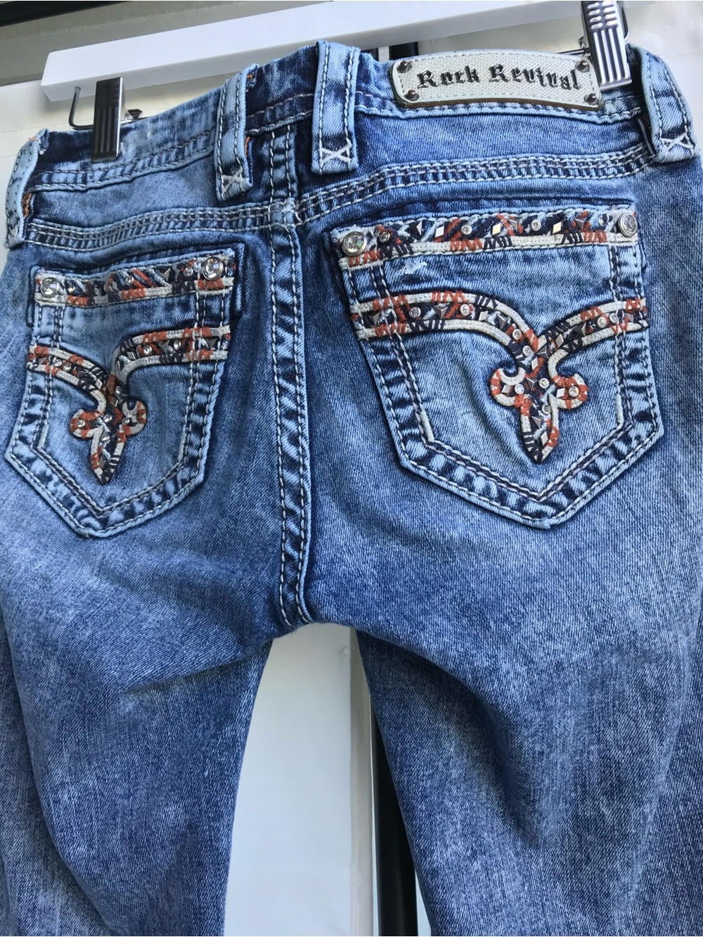 Rock Revival with orange embellishing on pockets.